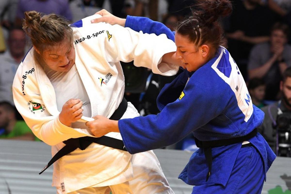 Germany's Anna-Monta Olek (Blue) and Belgium's Gabrielle Bouvier (White) compete in the women's +70 kg bout during the Judo's European Championships in Podgorica, on April 27, 2025. The tournament is taking place from April 23 to 27, 2025. SAVO PRELEVIC / AFP