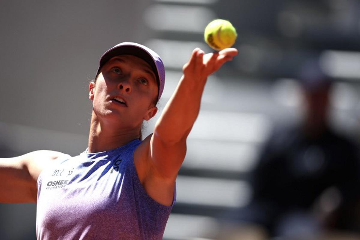 Poland's Iga Swiatek serves to Romania's Jaqueline Cristian during their women's singles match on day 6 of the French Open tennis tournament on Court Suzanne-Lenglen at the Roland-Garros Complex in Paris on May 30, 2025. Anne-Christine POUJOULAT / AFP