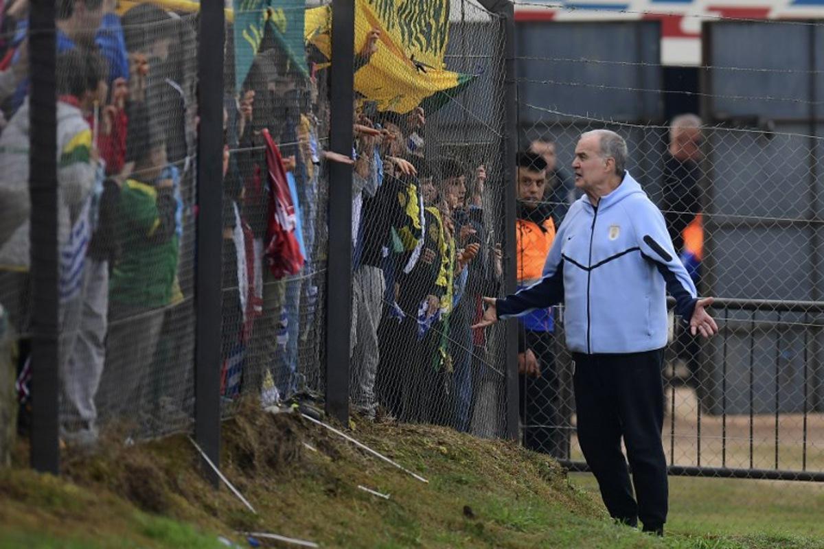 Uruguay's fnational football team coach, Argentinian Marcelo Bielsa, greets fans during a farewell activity with children ahead of the departure of the squad for the FIFA World Cup 2026, at the Tito Lopez Lopez stadium in Pando, Canelones department, Uruguay on June 5, 2026. Dante FERNANDEZ / AFP