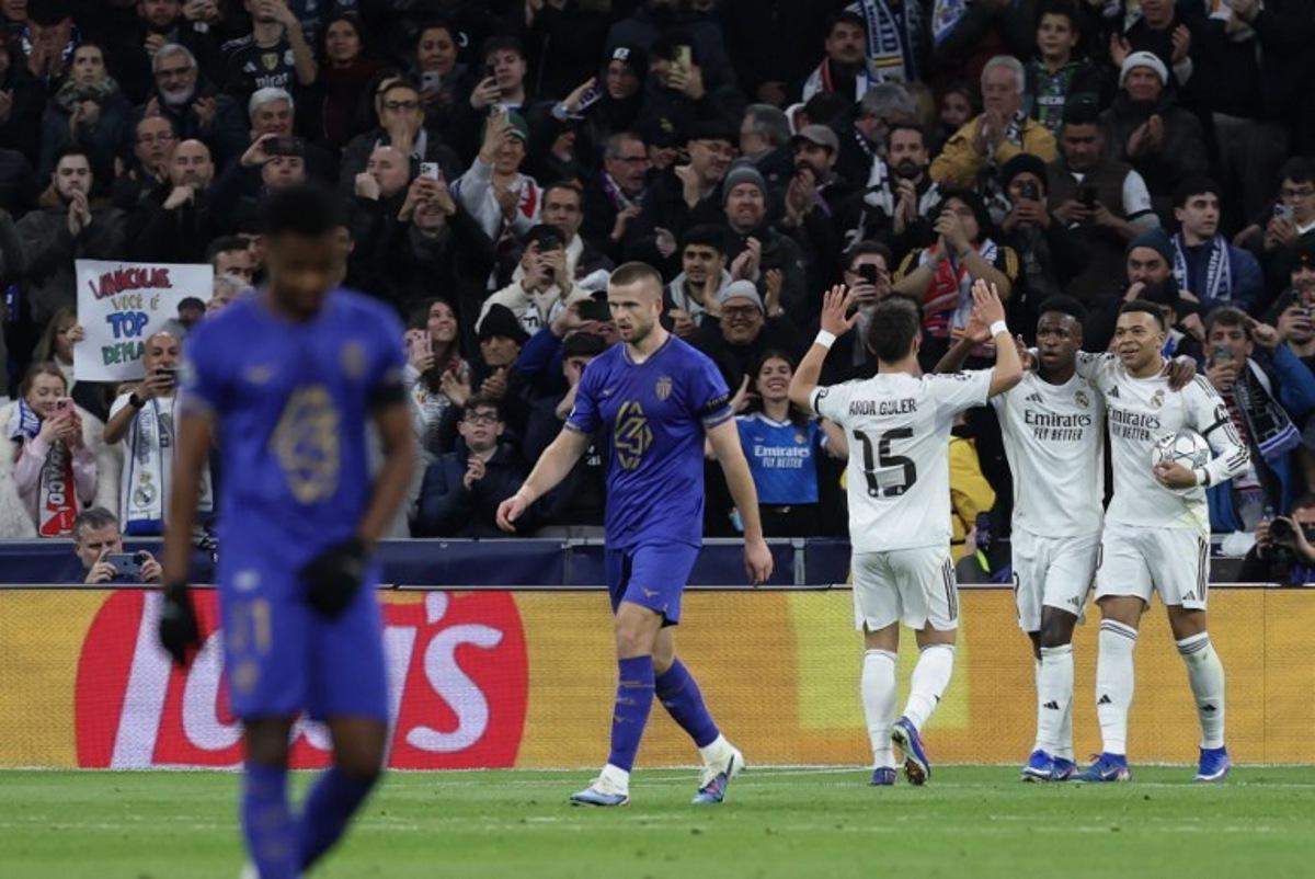 Real Madrid's French forward #10 Kylian Mbappe (R) celebrates scoring his team's second goal with teammates Real Madrid's Brazilian forward #07 Vinicius Junior and Real Madrid's Turkish midfielder #15 Arda Guler during the UEFA Champions League league phase day 7 football match between Real Madrid CF and AS Monaco at Santiago Bernabeu Stadium in Madrid on January 20, 2026. Thomas COEX / AFP