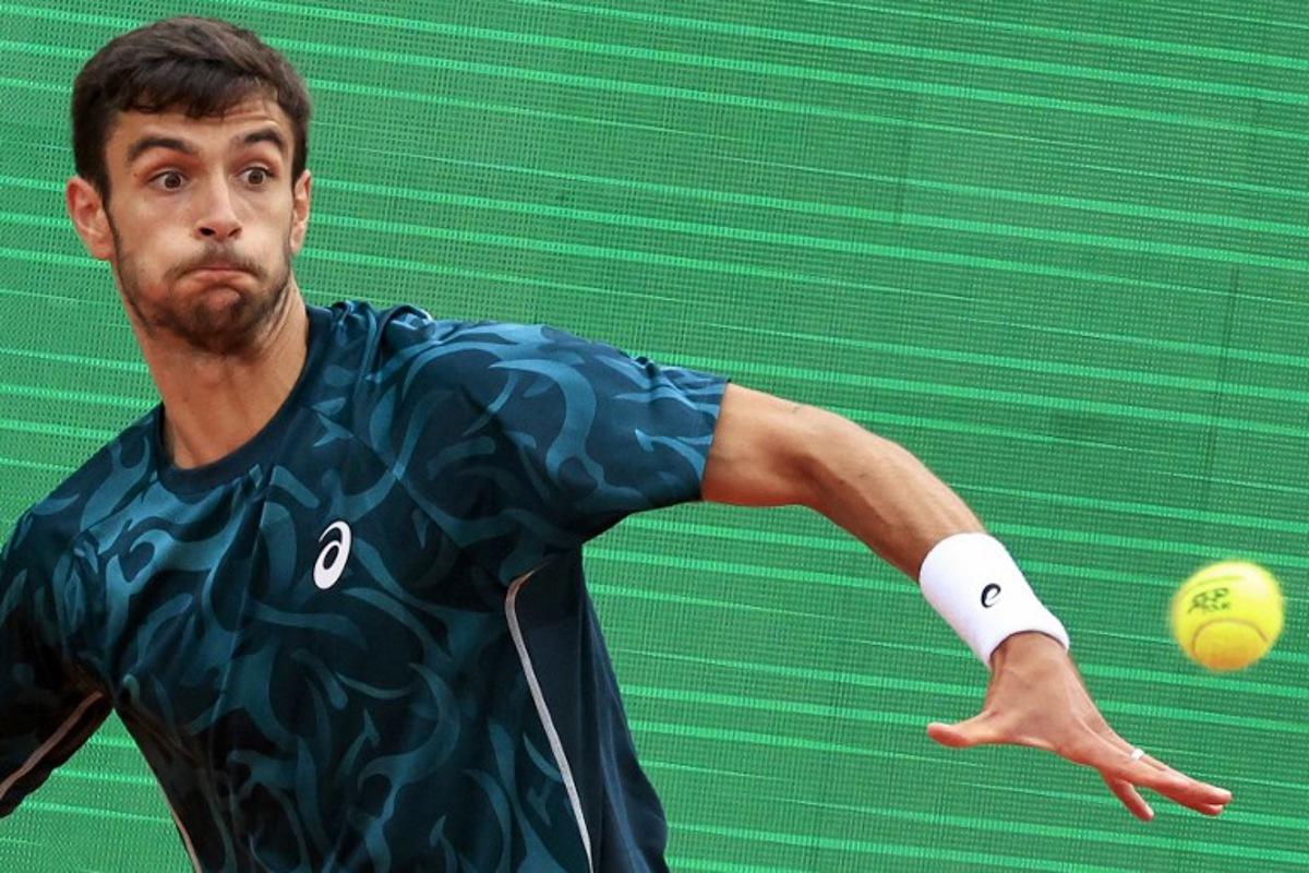 Italy's Lorenzo Musetti eyes the ball as he plays against Australia's Alex De Minaur during the Monte Carlo ATP Masters Series Tournament semi-final tennis match at the Monte Carlo Country Club in Roquebrune-Cap-Martin on April 12, 2025. Valery HACHE / AFP