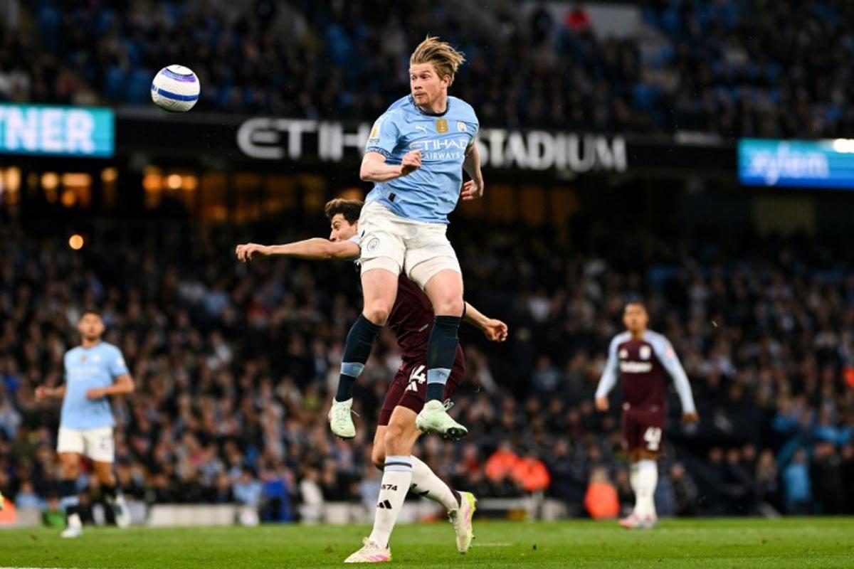 Manchester City's Belgian midfielder #17 Kevin De Bruyne heads the ball during the English Premier League football match between Manchester City and Aston Villa at the Etihad Stadium in Manchester, north west England, on April 22, 2025. Oli SCARFF / AFP