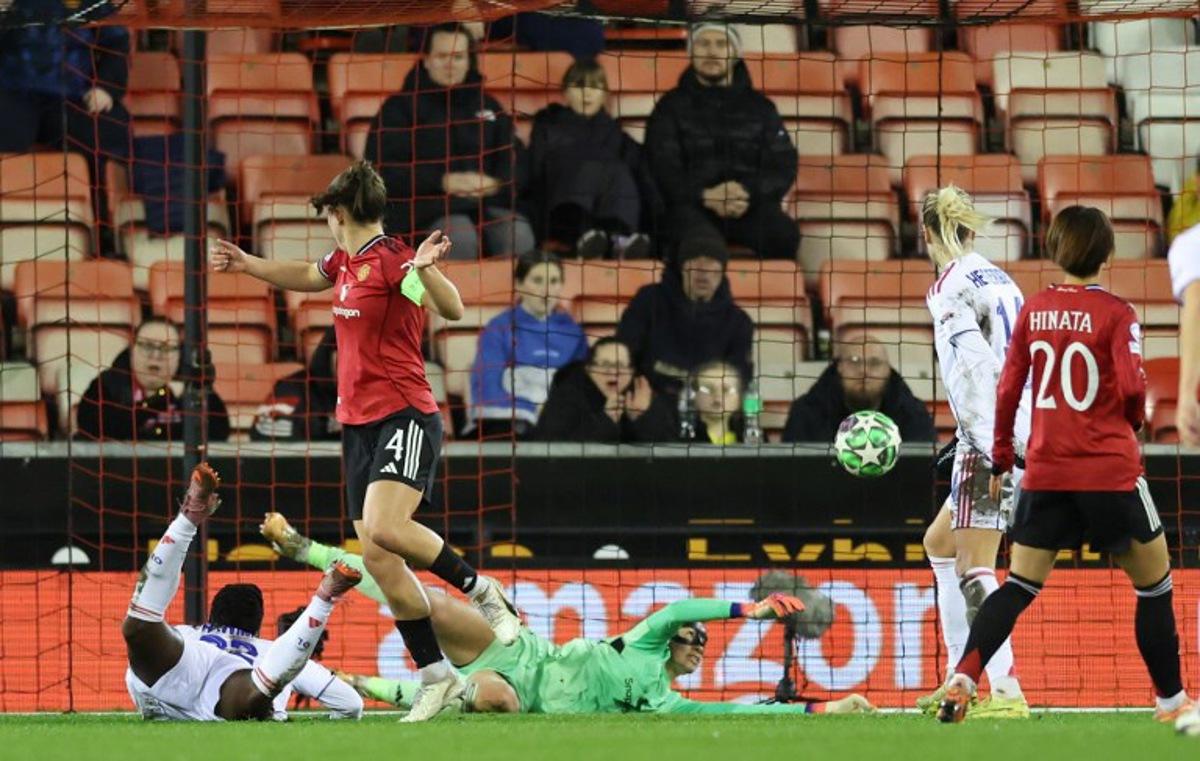 Lyon's Malawi forward #22 Tabitha Chawinga (L) scores the opening goal during the UEFA Women's Champions League, league phase football match between Manchester United and OL Lyonnes at the Progress With Unity Stadium in Leigh, western Manchester, on December 10, 2025. Darren Staples / AFP