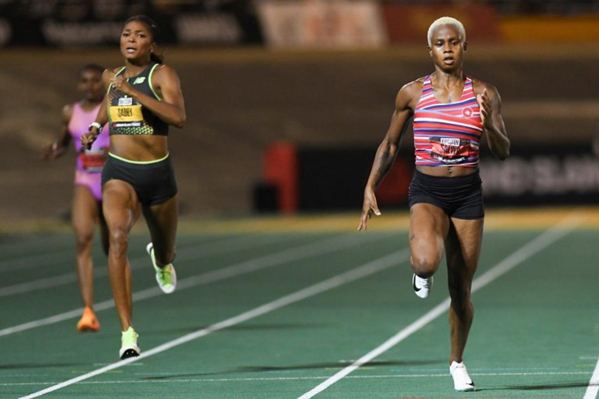 Bahrain's Salwa Eid Naser (R) comes in first ahead of USA's Gabby Thomas during the women's 400m event during the Grand Slam Track competition at the National Stadium in Kingston, Jamaica, on April 5, 2025. Ricardo Makyn / AFP