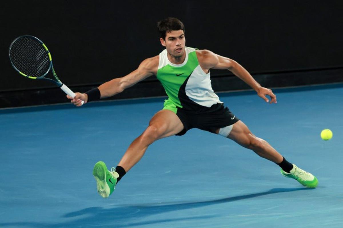 Spain's Carlos Alcaraz hits a return against Serbia's Novak Djokovic during their men's singles final match on day fifteen of the Australian Open tennis tournament in Melbourne on February 1, 2026. DAVID GRAY / AFP