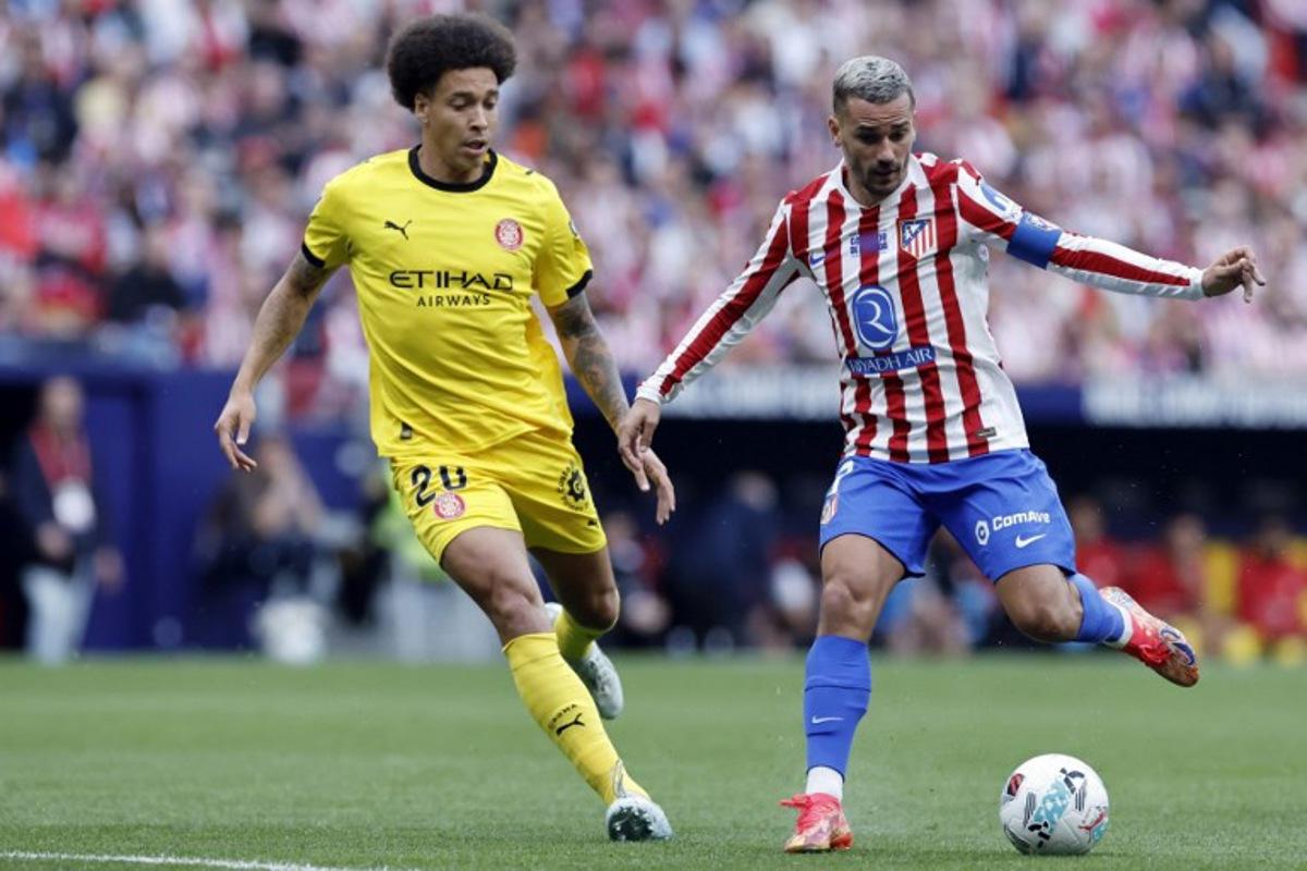 Girona's Belgian defender #20 Axel Witsel and Atletico Madrid's French forward #07 Antoine Griezmann vie for the ball during the Spanish league football match between Club Atletico de Madrid and Girona FC at the Metroplitano stadium in Madrid on May 17, 2026. Oscar DEL POZO / AFP