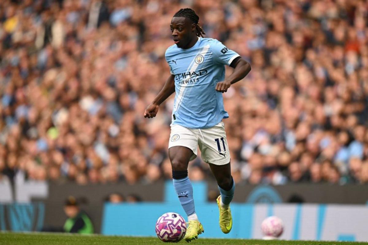 Manchester City's Belgian midfielder #11 Jeremy Doku runs with the ball during the English Premier League football match between Manchester City and Everton at the Etihad Stadium in Manchester, north west England, on October 18, 2025. Oli SCARFF / AFP