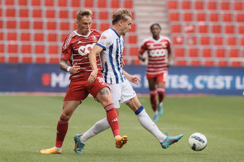 Standard's Jacob Barrett Laursen and Hertha Berlin's Marten Winkler fight for the ball during a friendly soccer match between Standard de Liege and Hertha Berlijn, Friday 21 July 2023 in Liege, in preparation of the upcoming 2023-2024 season. BELGA PHOTO BRUNO FAHY