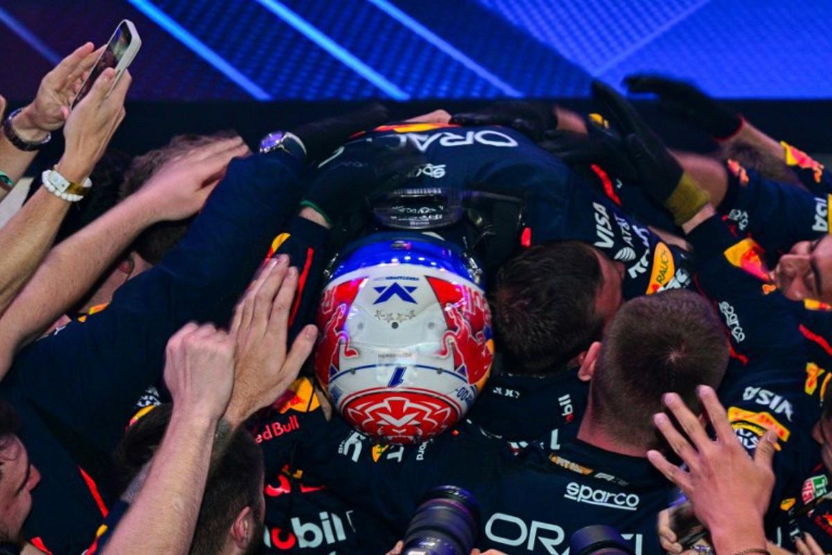 Red Bull Racing's Dutch driver Max Verstappen celebrates with his team after winning the Formula One Qatar Grand Prix at the Lusail International Circuit in Lusail on November 30, 2025. Andrej ISAKOVIC / AFP