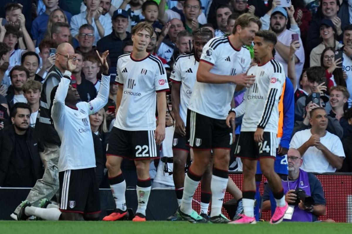 Fulham's players celebrate their first goal, an own-goal scored by Manchester United's Argentinian defender #06 Lisandro Martinez during the English Premier League football match between Fulham and Manchester United at Craven Cottage in London on September 20, 2026. CARLOS JASSO / AFP