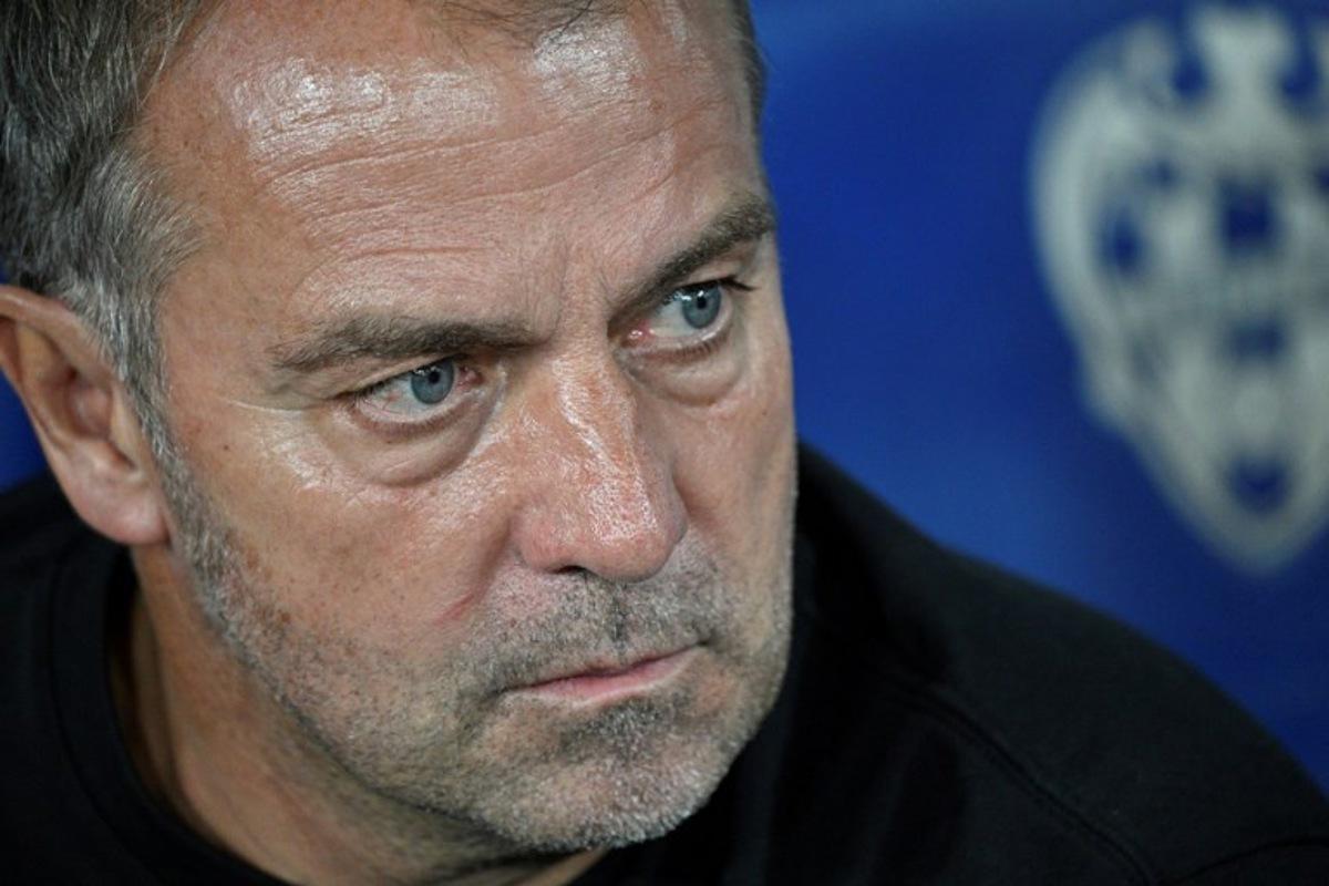 Barcelona's German coach Hans-Dieter Flick looks on prior the Spanish league football match between Levante UD and FC Barcelona at Ciutat de Valencia Stadium in Valencia on August 23, 2025. Jose JORDAN / AFP