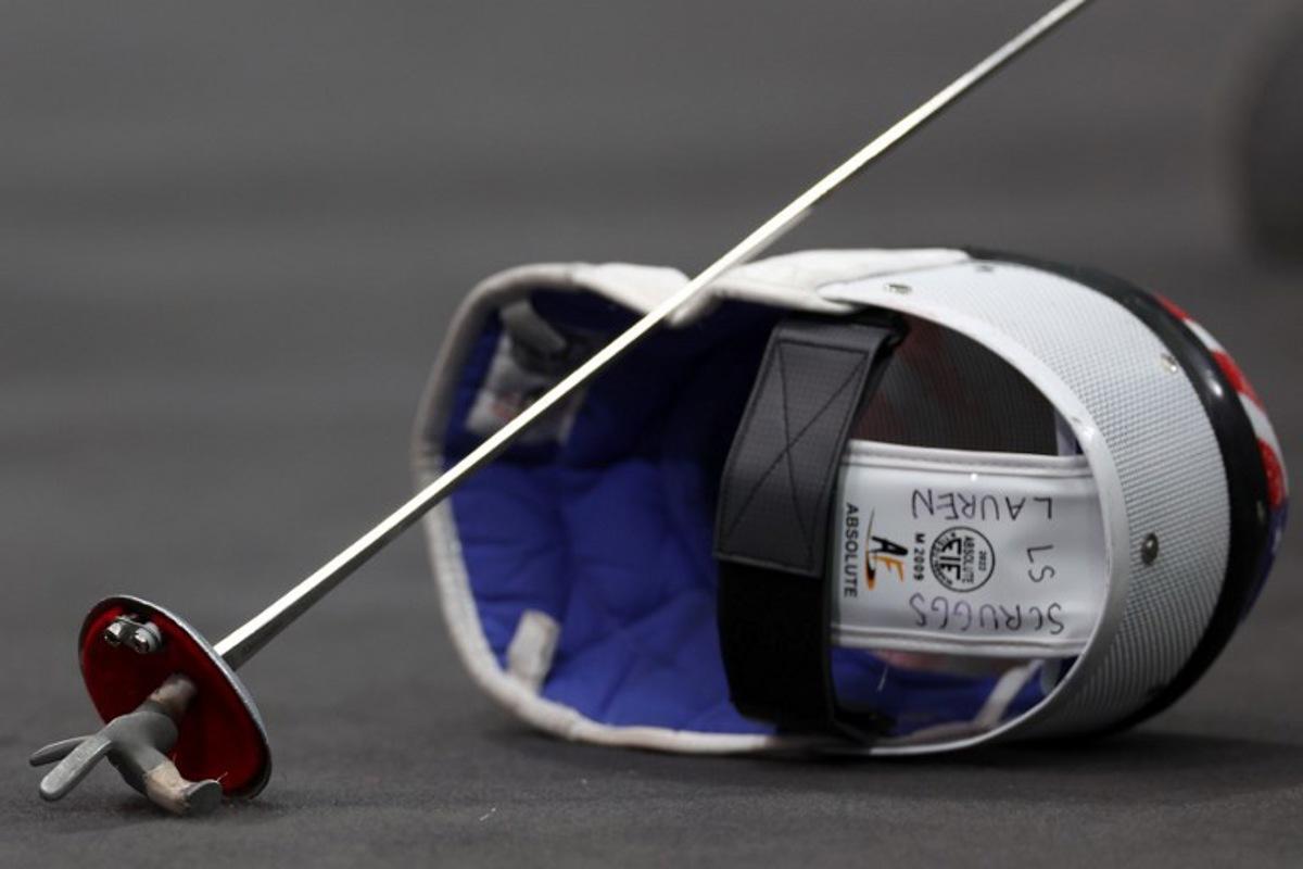 The helmet and sword of US' Lauren Scruggs are seen as she competes Canada in the women's foil team semi-final bout between Canada and USA during the Paris 2024 Olympic Games at the Grand Palais in Paris, on August 1, 2024. Franck FIFE / AFP