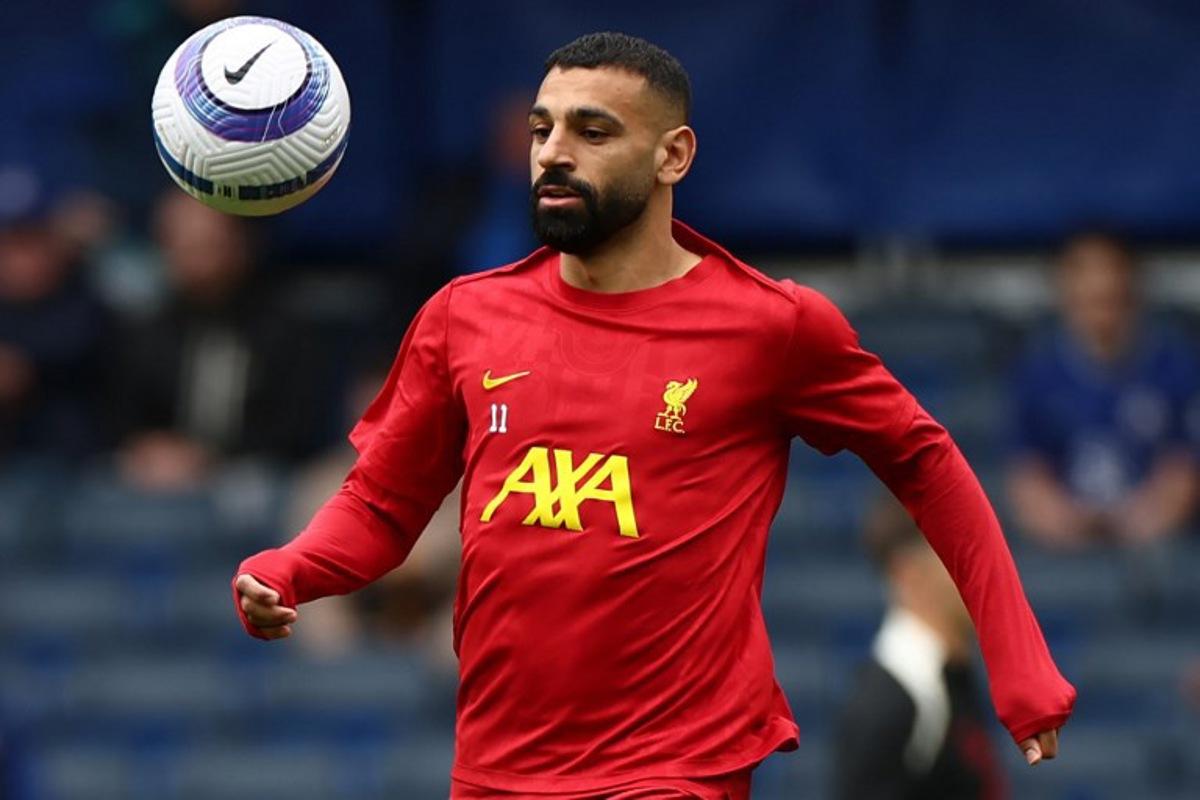 Liverpool's Egyptian striker #11 Mohamed Salah warms up ahead of the English Premier League football match between Chelsea and Liverpool at Stamford Bridge in London on May 4, 2025. HENRY NICHOLLS / AFP