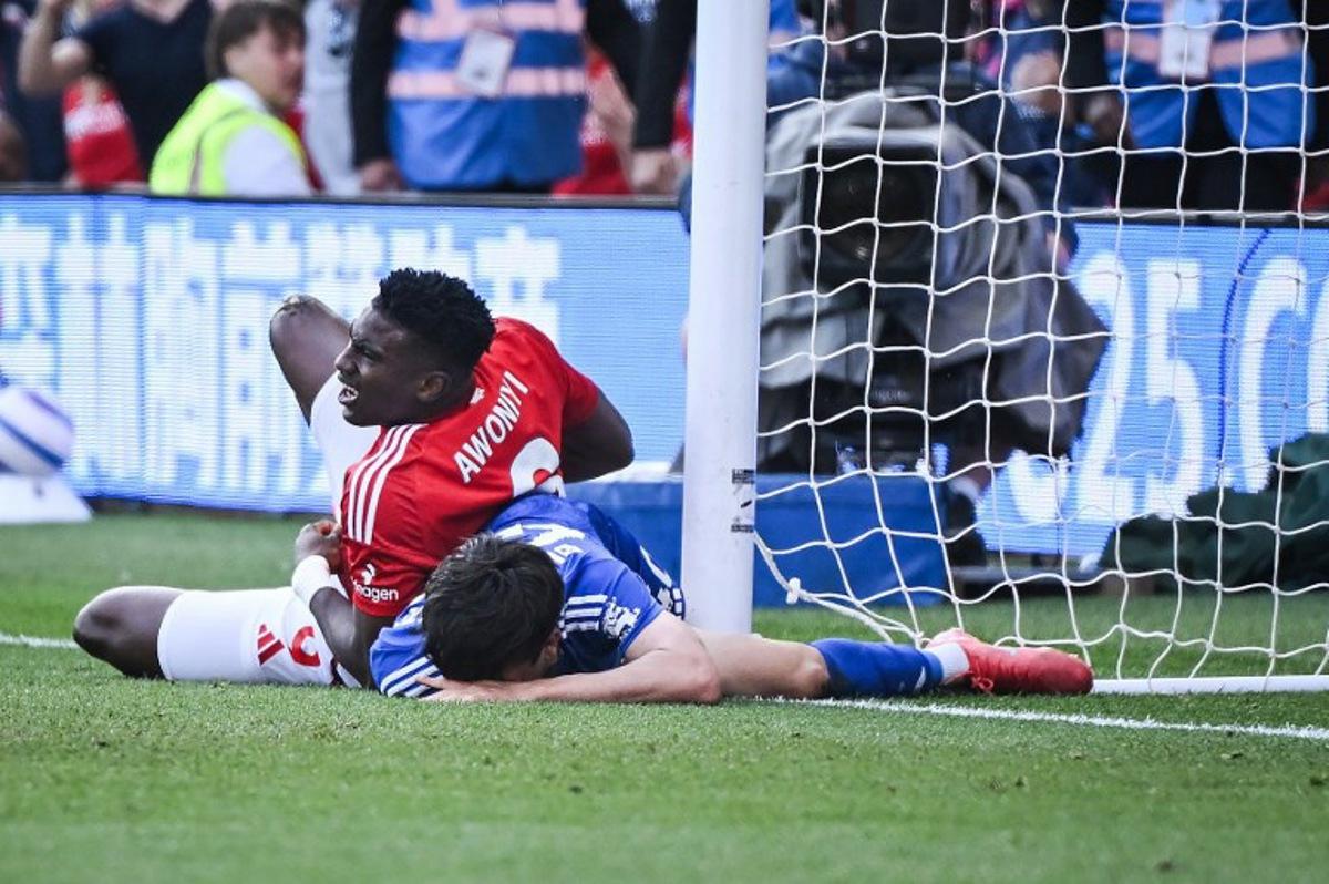 Nottingham Forest's Nigerian striker #09 Taiwo Awoniyi (L) and Leicester City's Argentinian midfielder #40 Facundo Buonanotte (R) react after colliding during the English Premier League football match between Nottingham Forest and Leicester City at The City Ground in Nottingham, central England, on May 11, 2025. JUSTIN TALLIS / AFP