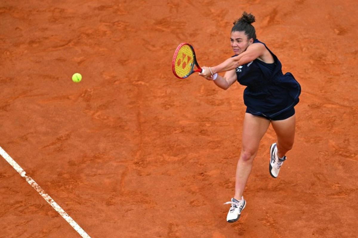 Italy's Jasmine Paolini plays a backhand return to USA's Coco Gauff during their women's singles final match for the WTA Rome Open tennis tournament at Foro Italico in Rome on May 17, 2025. Andreas SOLARO / AFP