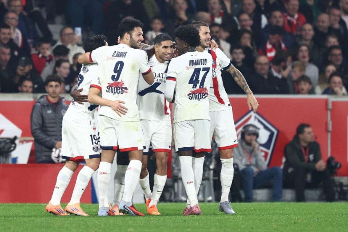 Paris Saint-Germain's players celebrate after scoring their first goal during the French L1 football match between Lille LOSC and Paris Saint-Germain (PSG) at the Stade Pierre-Mauroy in Villeneuve-d'Ascq, northern France, on October 5, 2025. Sameer AL-DOUMY / AFP
