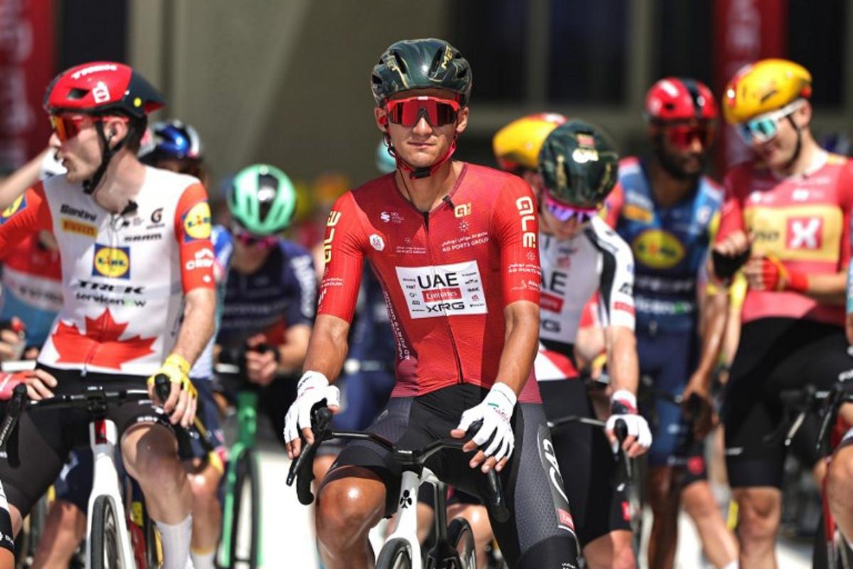 UAE Team Emirates's Mexican rider Isaac Del Toro Romero and other riders wait at the start line of the seventh and final stage of the UAE Tour cycling event from Zayed National Museum to Abu Dhabi Breakwater in Abu Dhabi on February 22, 2026. Fadel SENNA / AFP