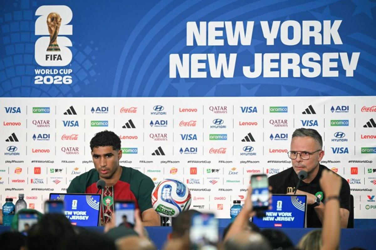Morocco's head coach Mohamed Ouahbi (R) speaks alongside Morocco's Achraf Hakimi during a press conference at the New York/New Jersey Stadium in East Rutherford on June 12, 2026, on the eve of the 2026 World Cup football match between Brazil and Morocco. Mauro PIMENTEL / AFP