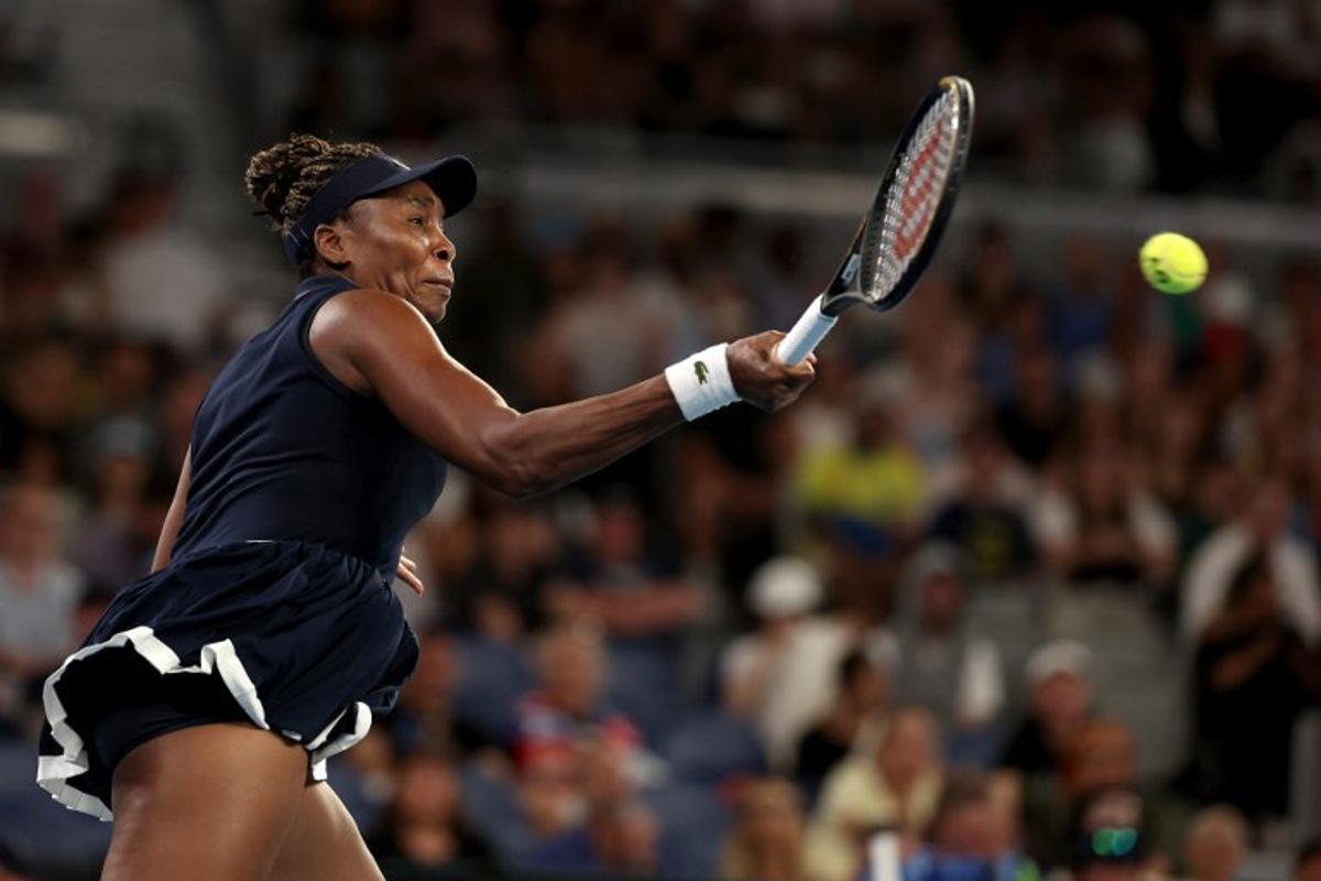 USA's Venus Williams hits a return to Serbia's Olga Danilovic during their women's singles match on day one of the Australian Open tennis tournament in Melbourne on January 18, 2026. Martin KEEP / AFP