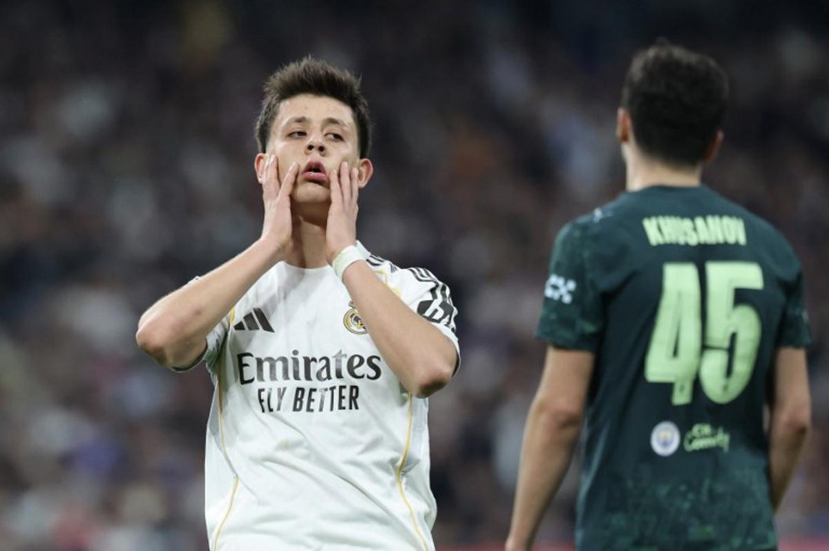Real Madrid's Turkish midfielder #15 Arda Guler (L) reacts during the UEFA Champions League last 16 first leg football match between Real Madrid CF and Manchester City at Santiago Bernabeu Stadium in Madrid on March 11, 2026. Thomas COEX / AFP