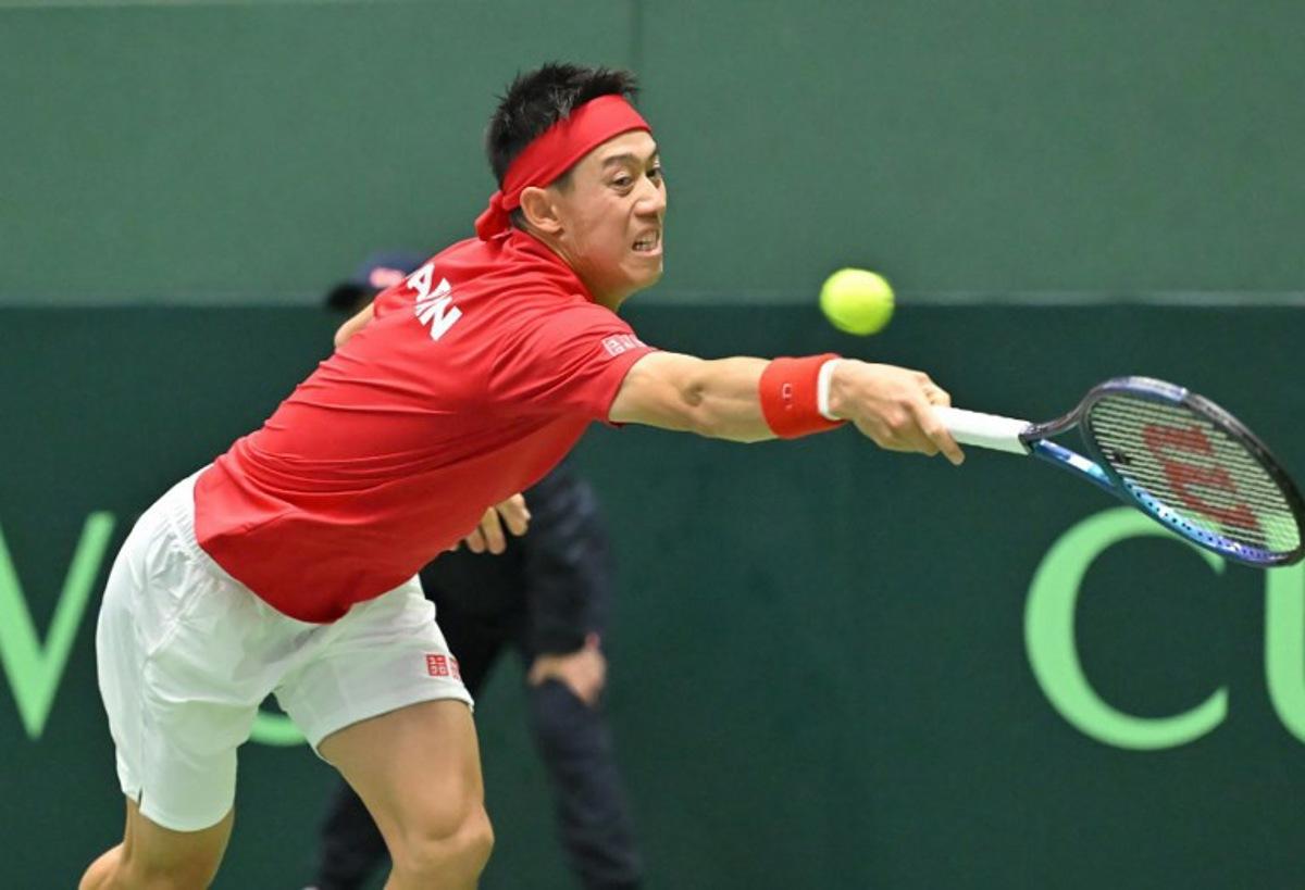 Japan's Kei Nishikori returns a shot against Britain's Jacob Fearnley during their men's singles match of the Davis Cup team tennis qualifiers at Bourbon Beans Dome in Miki, Hyogo Prefecture on January 31, 2025. STR / JIJI Press / AFP