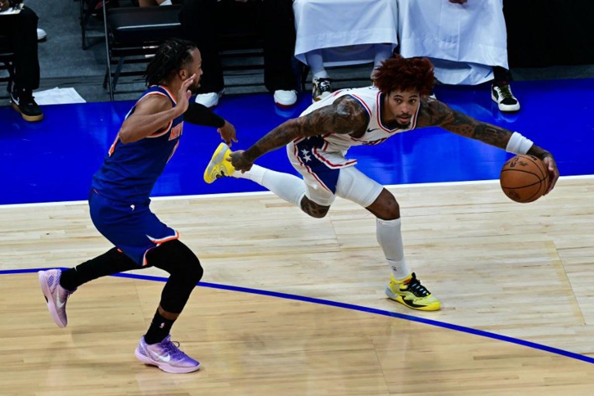 Philadelphia 76ers' #09 Kelly Oubre Jr. (R) dribbles against New York Knicks' #11 Jalen Brunson during the NBA basketball game between the New York Knicks and the Philadelphia 76ers at the Etihad Arena in Abu Dhabi on October 4, 2025. Giuseppe CACACE / AFP
