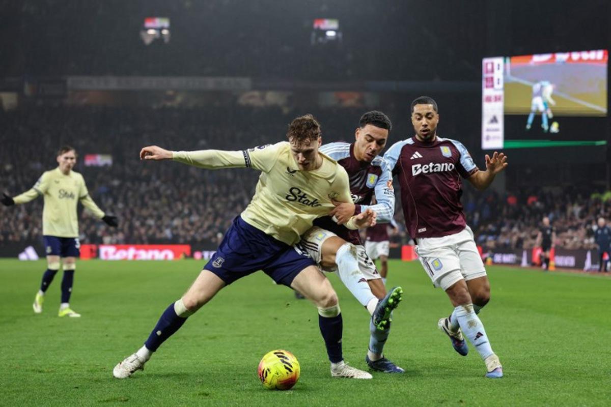 Everton's Irish defender #15 Jake O'Brien (front L) clashes with Aston Villa's English midfielder #27 Morgan Rogers (C) and Aston Villa's Belgian midfielder #08 Youri Tielemans (R) during the English Premier League football match between Aston Villa and Everton at Villa Park in Birmingham, central England on January 18, 2026. Darren Staples / AFP
