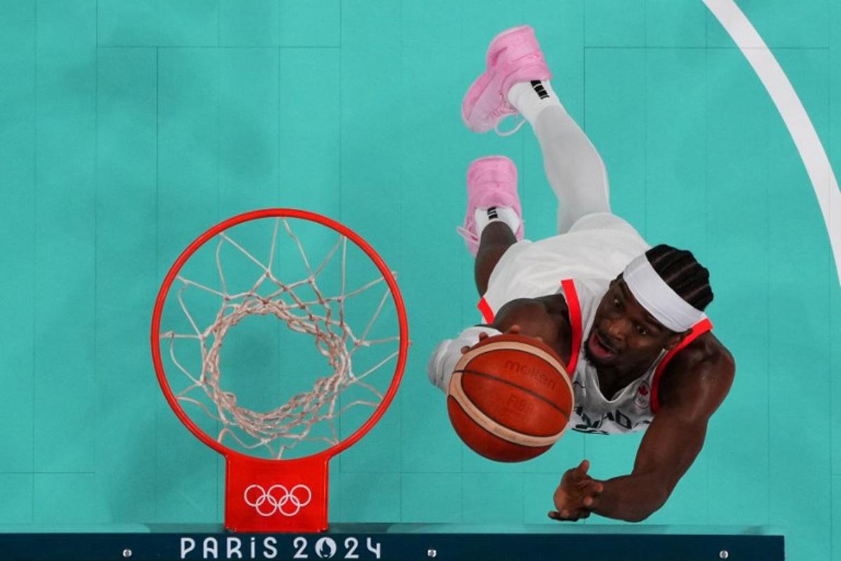 An overview shows Canada's #02 Shai Gilgeous-Alexander going for a rebound in the men's preliminary round group A basketball match between Canada and Australia during the Paris 2024 Olympic Games at the Pierre-Mauroy stadium in Villeneuve-d'Ascq, northern France, on July 30, 2024. POOL / AFP