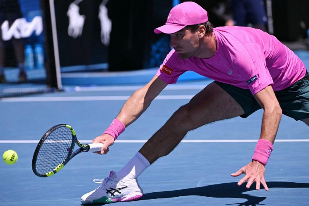 Belgium's Raphael Collignon hits a return against Italy's Lorenzo Musetti during their men's singles match on day three of the Australian Open tennis tournament in Melbourne on January 20, 2026. WILLIAM WEST / AFP