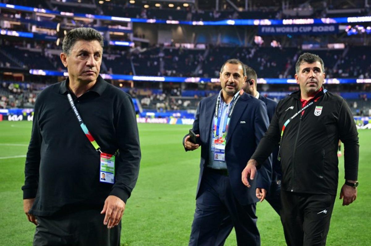 Iran's head coach Amir Ghalenoei (L) walks out the pitch after the 2026 World Cup Group G football match between Iran and New Zealand at Los Angeles Stadium in Inglewood on June 15, 2026. Frederic J. Brown / AFP
