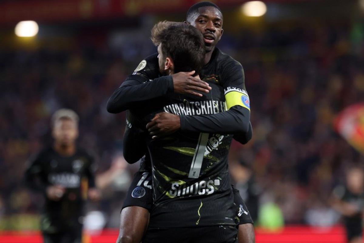 Paris Saint-Germain's Georgian forward #07 Khvicha Kvaratskhelia (front) is congratulated by Paris Saint-Germain's French forward #10 Ousmane Dembele after scoring a goal during the French L1 football match between RC Lens and Paris Saint-Germain (PSG) at the Stade Bollaert-Delelis stadium in Lens on May 13, 2026. Francois LO PRESTI / AFP