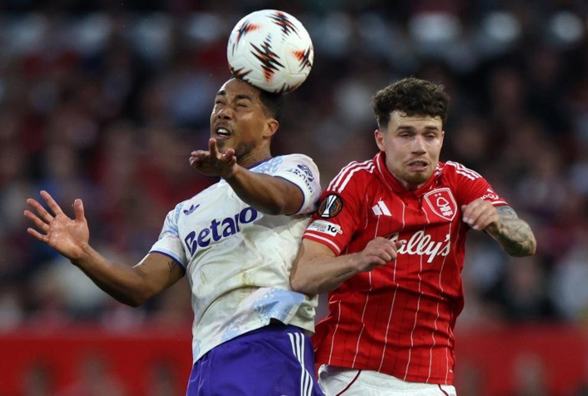 Aston Villa's Belgian midfielder #08 Youri Tielemans jumps above Nottingham Forest's Welsh defender #03 Neco Williams to header the ball during the UEFA Europa League semi-final first-leg football match between Nottingham Forest and Aston Villa at The City Ground in Nottingham, central England, on April 30, 2026. Darren Staples / AFP