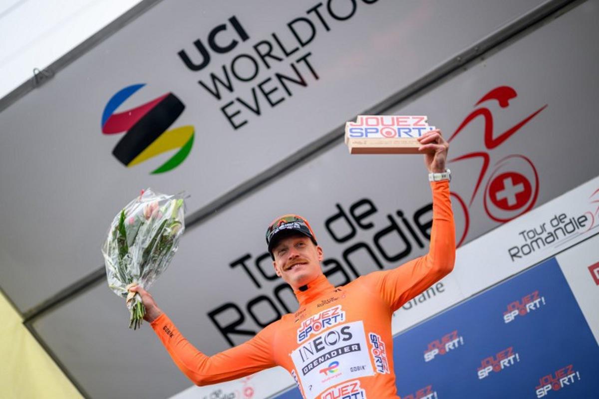 INEOS Grenadiers' French rider Dorian Godon celebrates on the podium after winning the prologue of the Tour of Romandie UCI cycling World tour, a 3.2 km time trial from Villars-sur-Glane to Villars-sur-Glane on April 28, 2026. Fabrice COFFRINI / AFP