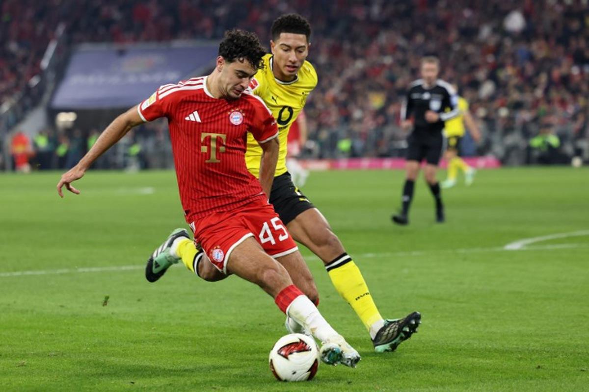 Bayern Munich's German midfielder #45 Aleksandar Pavlovic and Dortmund's English midfielder #07 Jobe Bellingham vie for the ball during the German first division Bundesliga football match between FC Bayern Munich and BVB Borussia Dortmund in Munich, southern Germany, on October 31, 2026. Alexandra BEIER / AFP