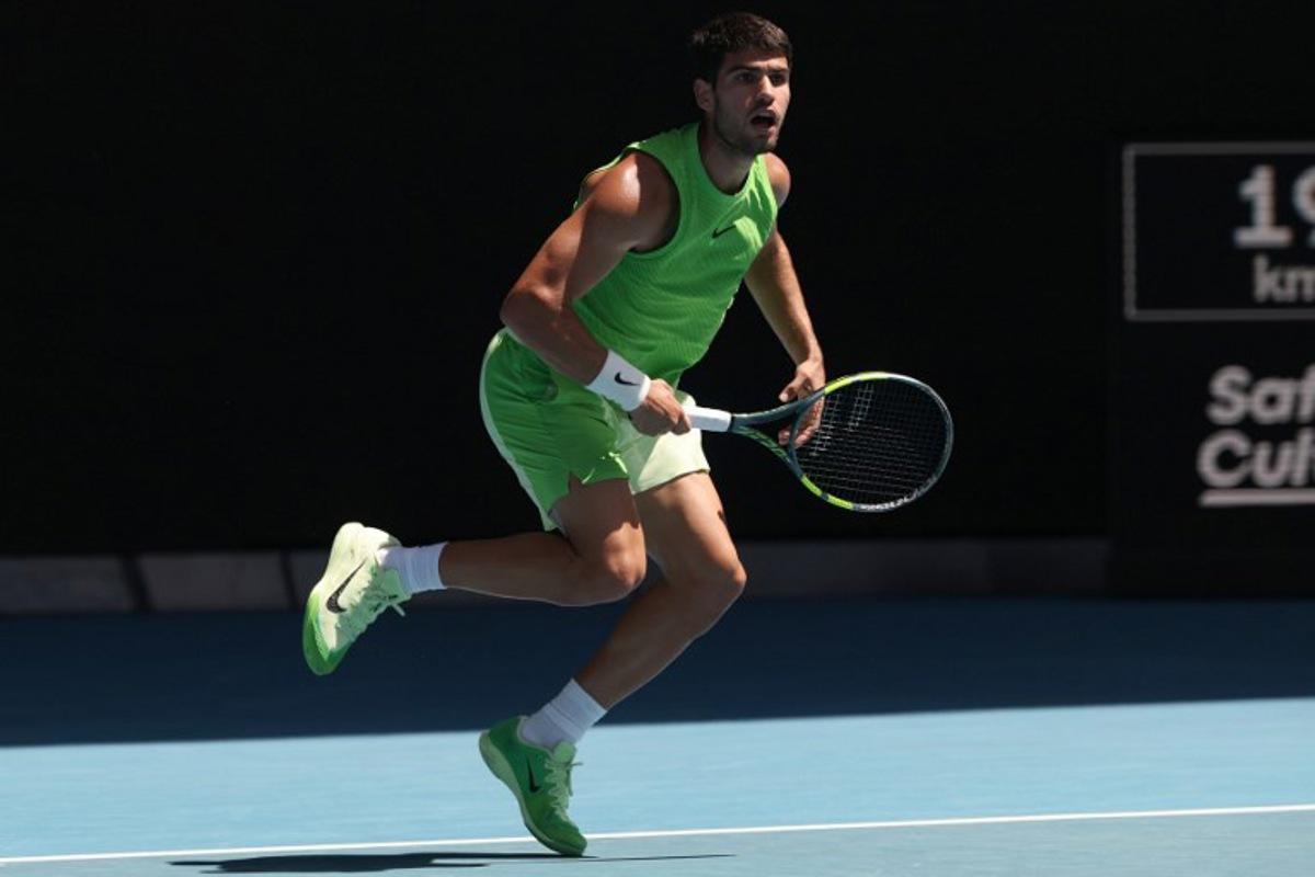 Spain's Carlos Alcaraz hits a return against USA's Tommy Paul during their men's singles match on day eight of the Australian Open tennis tournament in Melbourne on January 25, 2026. DAVID GRAY / AFP