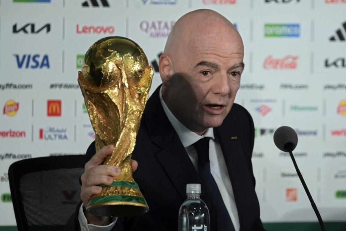 Gianni Infantino holds the World Cup trophy during a press conference on the eve of the opening match of the 2026 World Cup football tournament at Mexico city stadium in Mexico City on June 10, 2026. Alfredo ESTRELLA / AFP