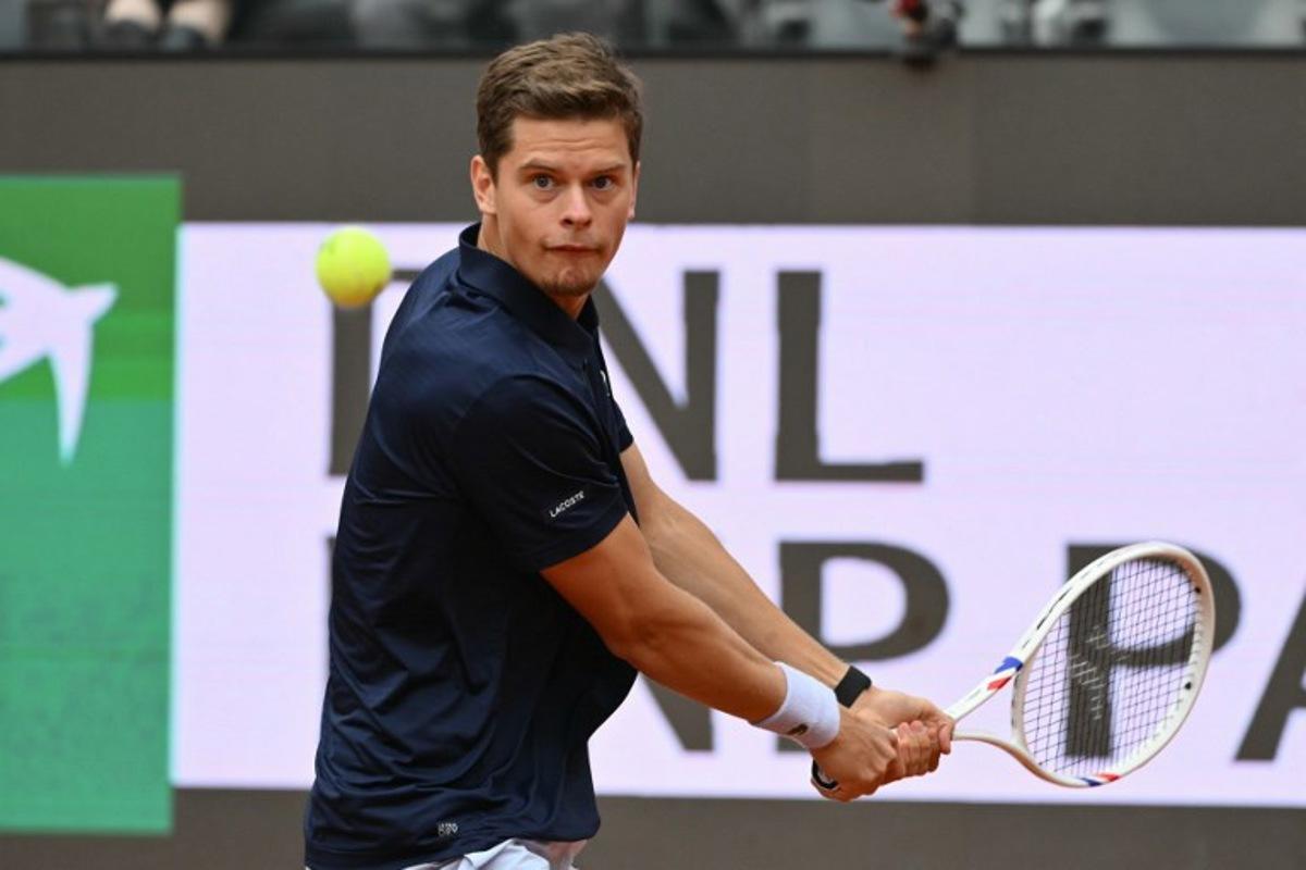 Belgium's Alexander Blockx hits a return to Germany's Alexander Zverev during their men's singles match at the WTA Rome Open tennis tournament at Foro Italico in Rome on May 10, 2026. Alberto PIZZOLI / AFP