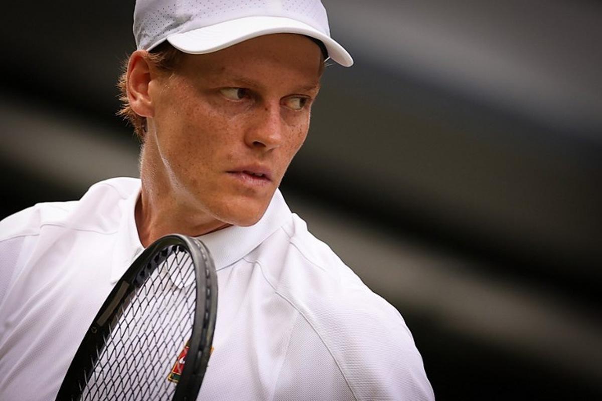 Italy's Jannik Sinner reacts as he plays against US player Ben Shelton during their men's singles quarter-final tennis match on the tenth day of the 2025 Wimbledon Championships at The All England Lawn Tennis and Croquet Club in Wimbledon, southwest London, on July 9, 2025. HENRY NICHOLLS / AFP