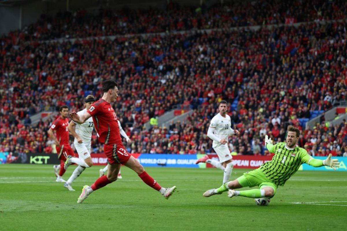Liechtenstein's goalkeeper #01 Benjamin Buchel saves this shot from Wales' forward #13 Kieffer Moore (L) during the 2026 World Cup Group J qualifier football match between Wales and Liechtenstein, at Cardiff City Stadium, in Cardiff, on June 6, 2025. Darren Staples / AFP