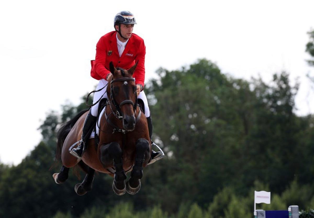 Germany's Richard Vogel with horse United Touch S competes in the equestrian's jumping team qualifier during the Paris 2024 Olympic Games at the Chateau de Versailles, in Versailles, in the western outskirts of Paris, on August 1, 2024. Pierre-Philippe MARCOU / AFP