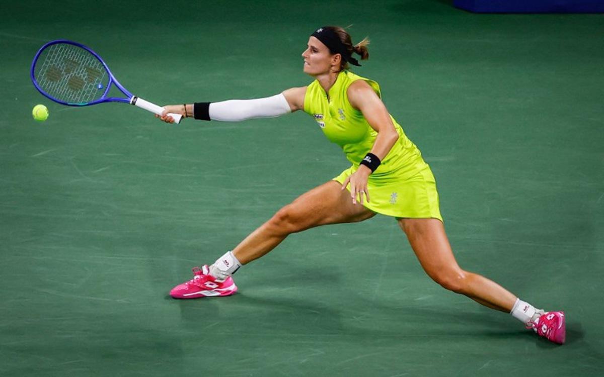 Belgium's Greet Minnen returns the ball to Japan's Naomi Osaka during their women's singles first round tennis match on day three of the US Open tennis tournament at the USTA Billie Jean King National Tennis Center in New York City, on August 26, 2025. Kena Betancur / AFP