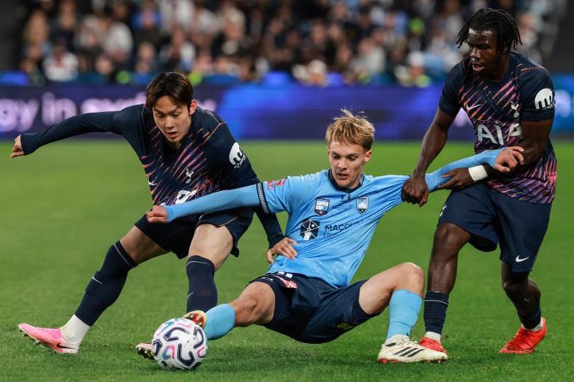 Sydney's Joseph Lacey (C) fights for the ball with Tottenham's Yang Min-hyeok (L) and Tottenham's Rio Kyerematen (R) during the Sydney Super Cup football match between Tottenham Hotspur and Sydney FC at the Allianz Stadium in Sydney on July 29, 2026. DAVID GRAY / AFP