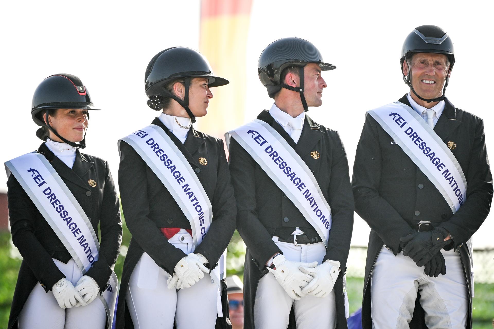 Belgian Charlotte Defalque, Belgian Larissa Pauluis, Belgian Justin Verboomen and Belgian Wim Verwimp pictured during the podium ceremony after the Dressage Nations Cup FEI CDIO4 equestrian event in Koningshooikt, Lier on Saturday 23 May 2026. BELGA PHOTO ELIAS ROM