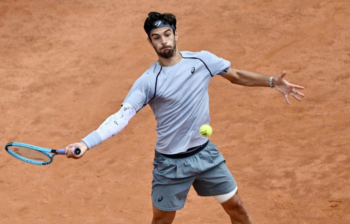 Italy's Lorenzo Musetti hits a return to Norway's Casper Ruud during the ATP Rome Open tennis tournament at Foro Italico in Rome on May 12, 2026. Tiziana FABI / AFP