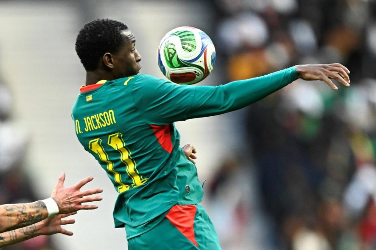 Senegal's forward #11 Nicolas Jackson jumps to control the ball during the international friendly football match between Senegal and Peru at the Stade de France in Saint-Denis, north of Paris, on March 28, 2026. JULIEN DE ROSA / AFP