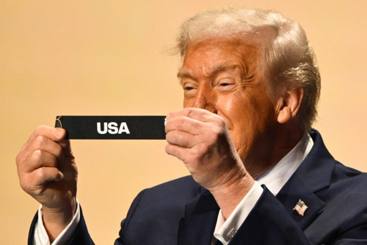 US President Donald Trump shows the card reading USA during the draw for the 2026 FIFA Football World Cup taking place in the US, Canada and Mexico, at the Kennedy Center, in Washington, DC, on December 5, 2025. Mandel NGAN / POOL / AFP