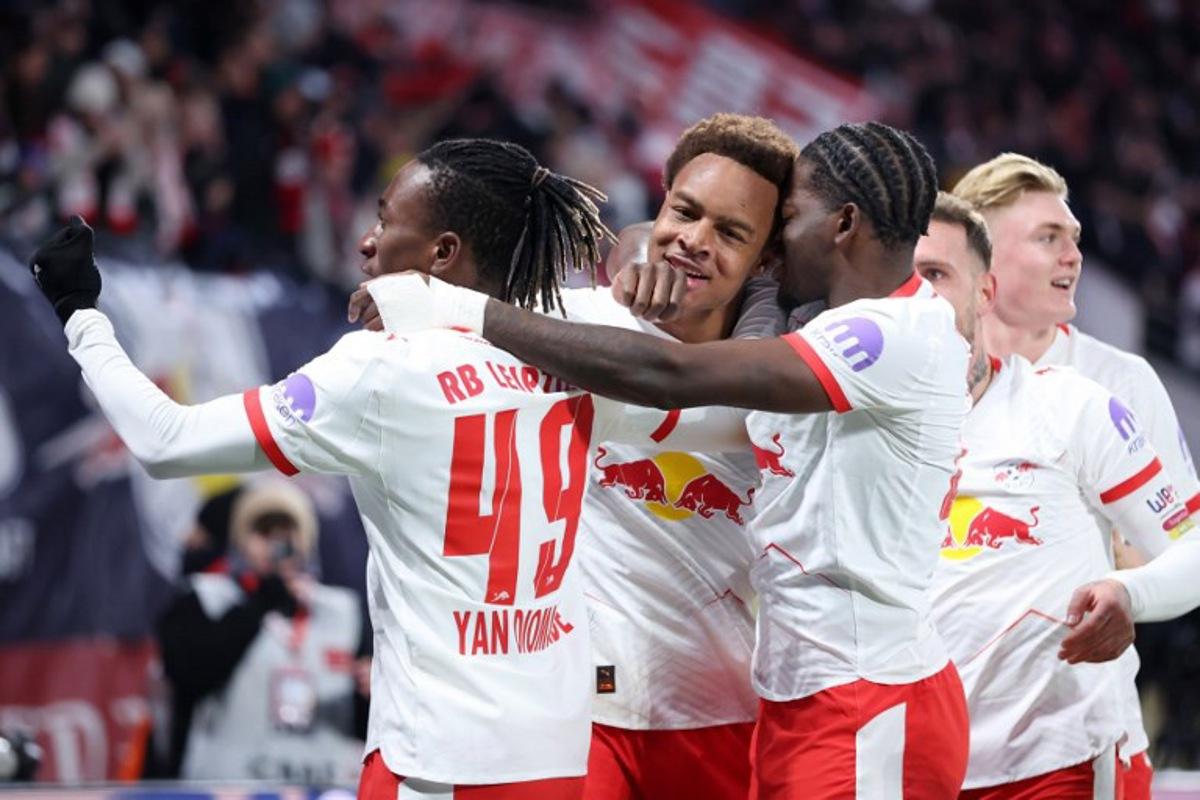 Leipzig's German midfielder #20 Assan Ouedraogo (2L) celebrates scoring his team's first goal with teammates during the German first division Bundesliga football match between RB Leipzig and Werder Bremen in Leipzig on November 23, 2025. Ronny HARTMANN / AFP