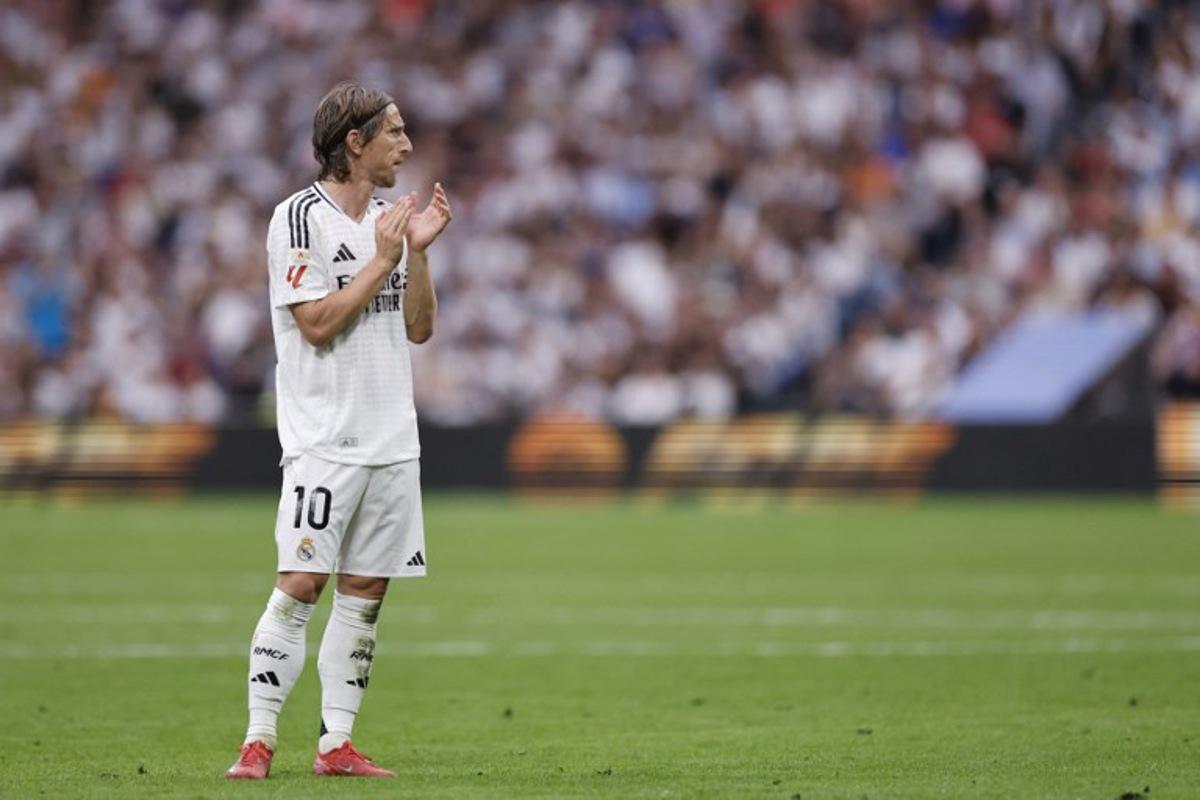Real Madrid's Croatian midfielder #10 Luka Modric claps during the Spanish league football match between Real Madrid CF and Real Sociedad at Santiago Bernabeu Stadium in Madrid on May 24, 2025. OSCAR DEL POZO / AFP