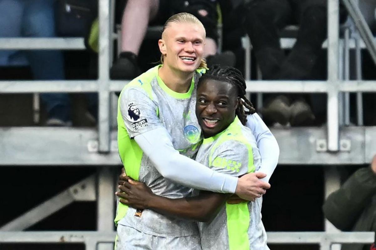 Manchester City's Norwegian striker #09 Erling Haaland (L) celebrates scoring the team's first goal during the English Premier League football match between Burnley and Manchester City at Turf Moor in Burnley, north-west England on April 22, 2026. Paul ELLIS / AFP