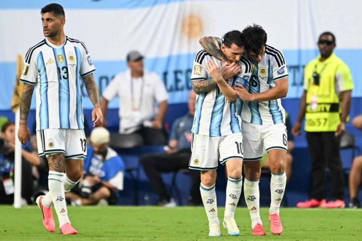 Argentina's defender #06 Lisandro Martinez celebrates with teammate Argentina's forward #10 Lionel Messi scoring his team's second goal next to Argentina's defender #13 Cristian Romero during the 2026 World Cup round of 32 football match between Argentina and Cape Verde at the Miami Stadium in Miami Gardens on July 3, 2026. ROBERTO SCHMIDT / AFP